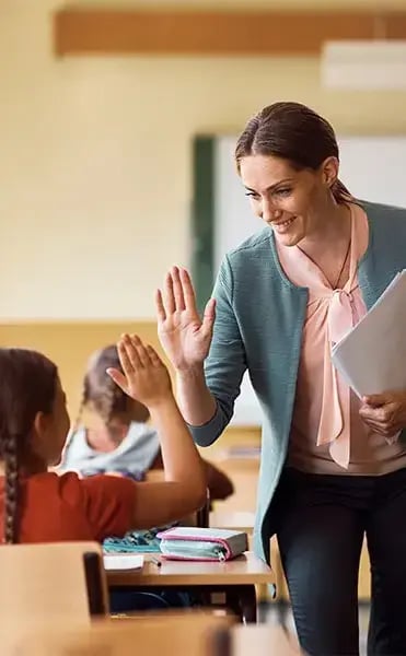 teacher-high-fives-student-Vertical