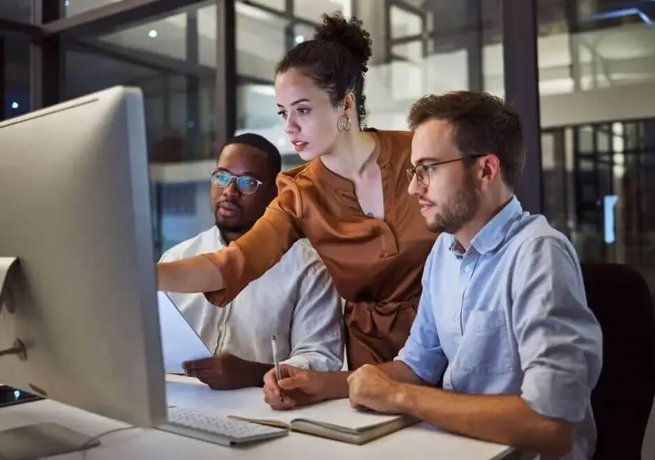 three people looking at data image
