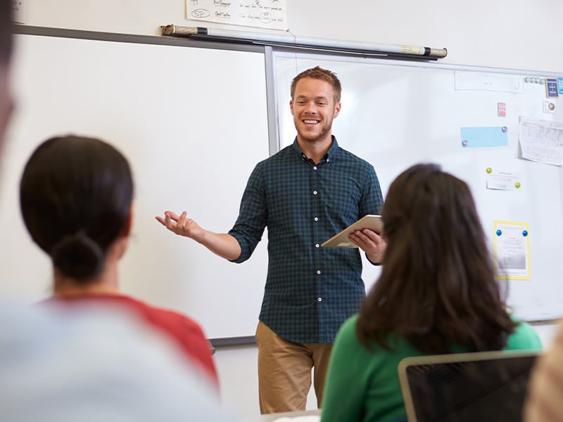 male teacher in front of classroom
