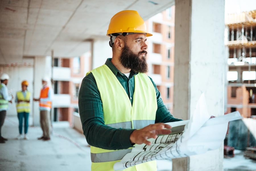 construction supervisor looking at plans