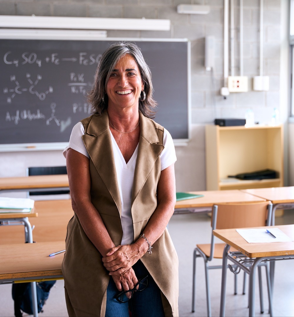 teacher in empty classroom