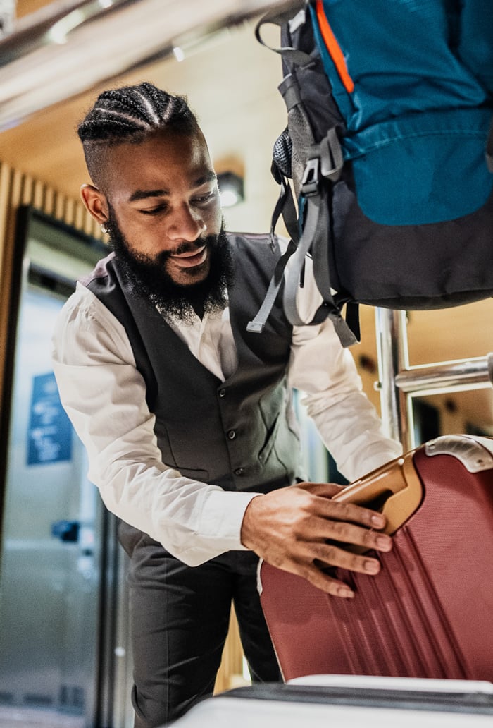 bellhop managing suitcase