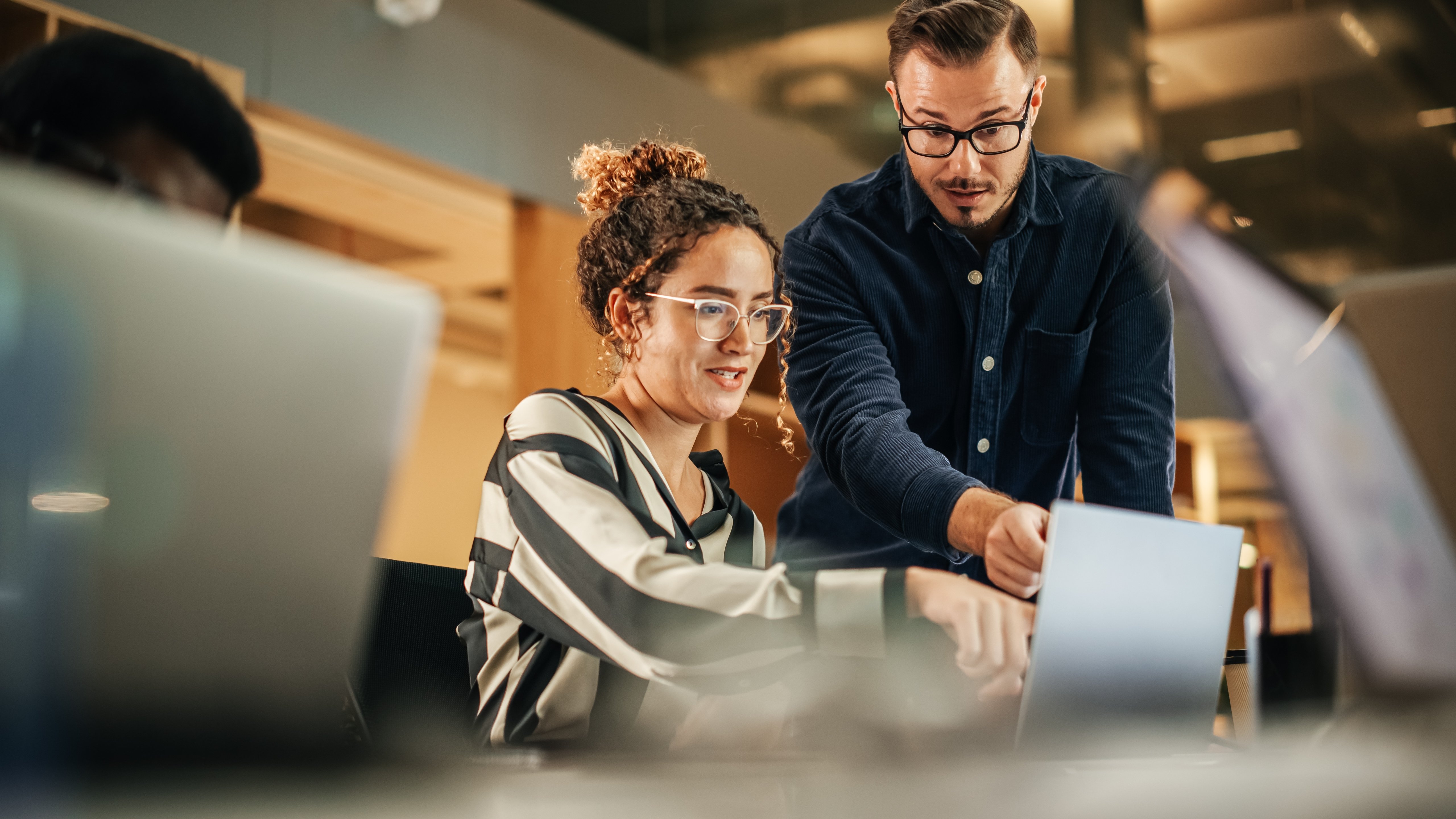 two employees looking at a computer