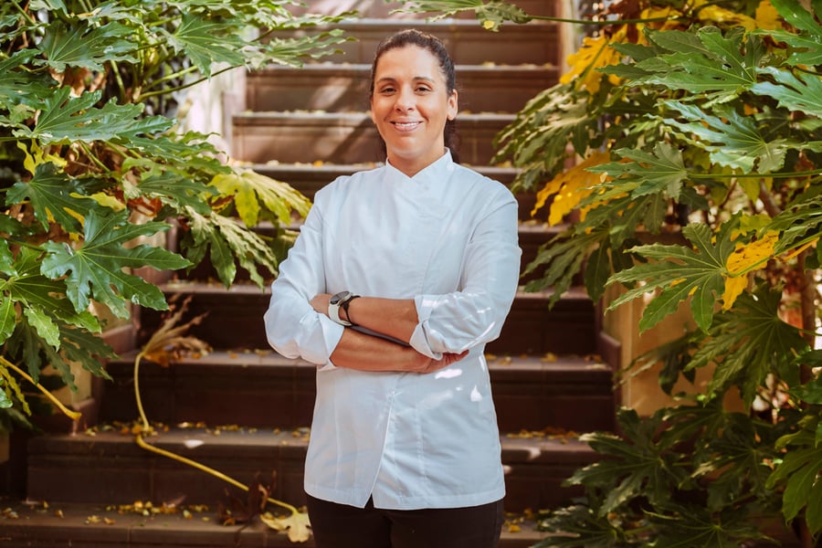 hotel chef in front of steps