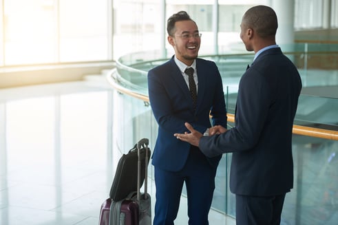 Business professionals talking in an airport