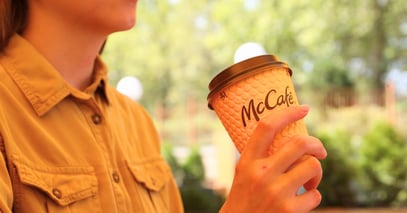 girl holding McDonald's coffee